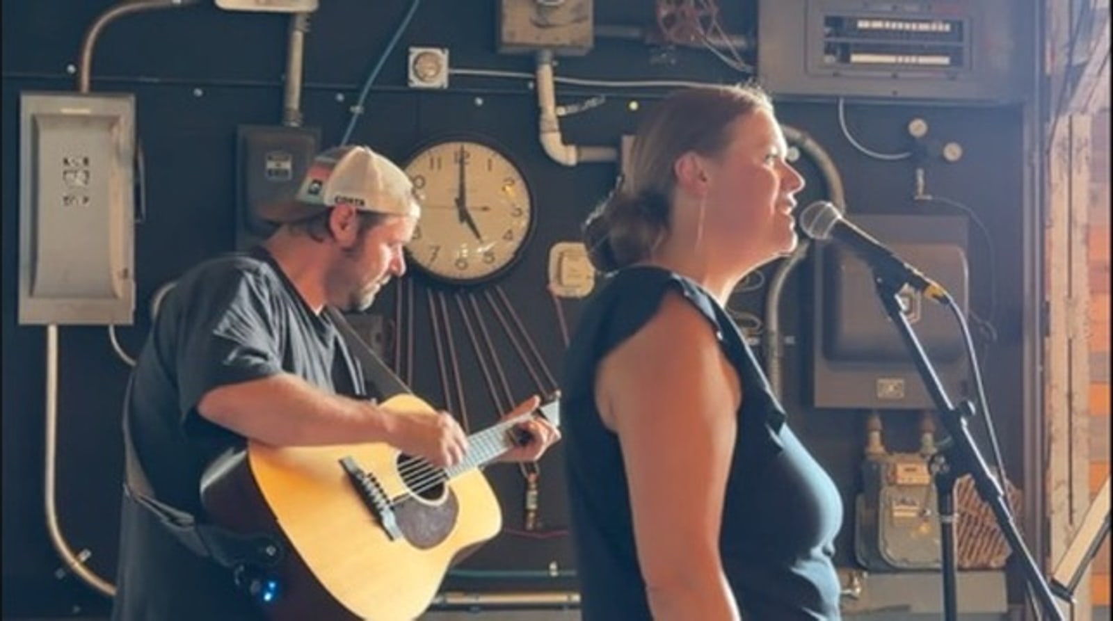Carrie singing while Dale plays acoustic guitar.