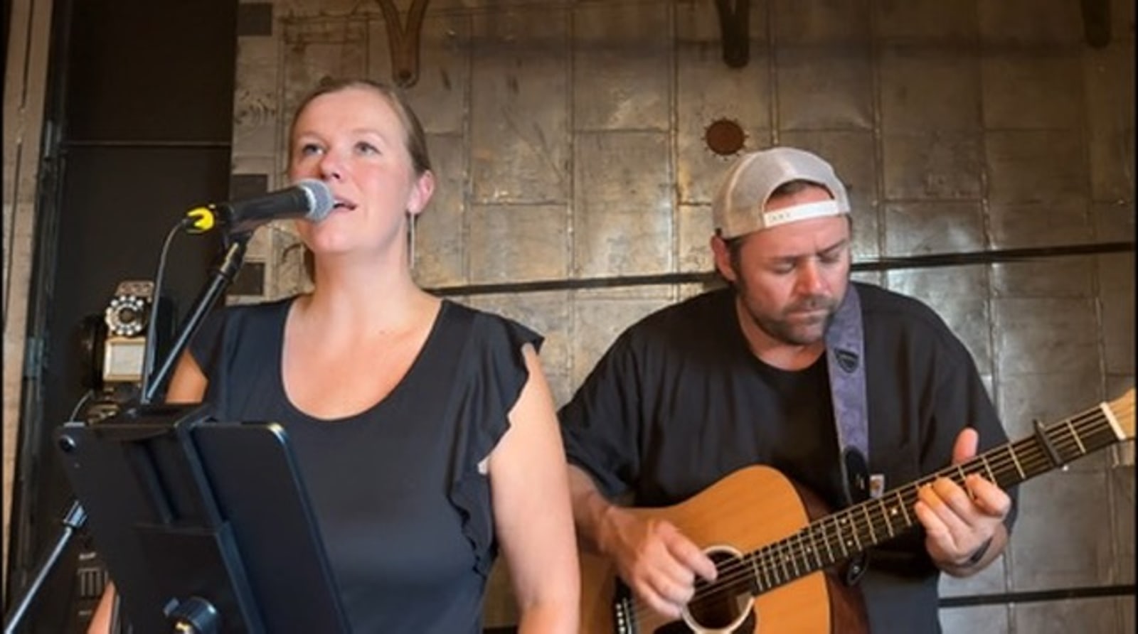 Carrie singing while Dale plays acoustic guitar.